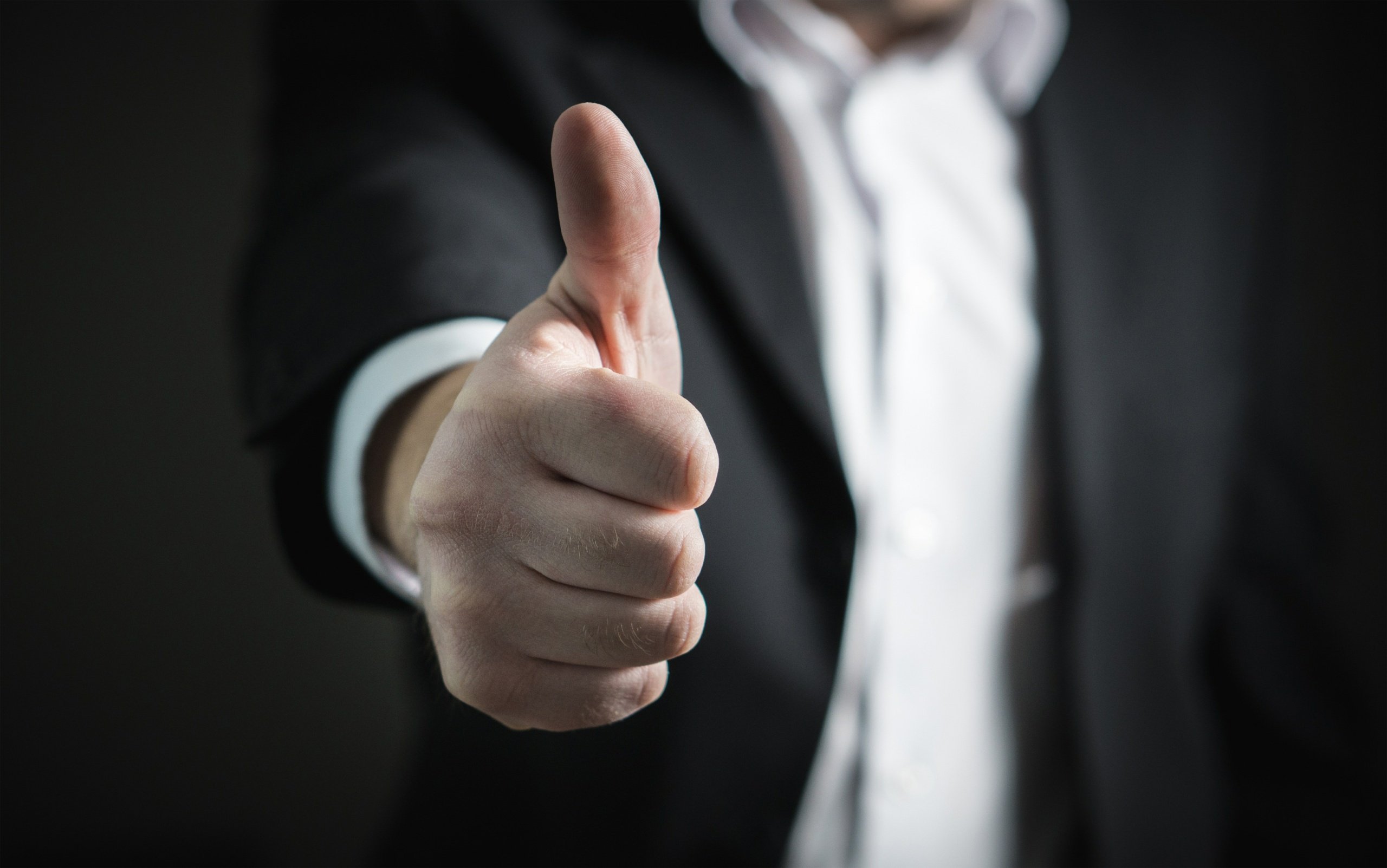 A photo of a thumbs-up, representing the benefits of risk management The benefits of risk management